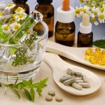 2019 Supplement Trends: What To Look For Alternative Medicine. herbs in a glass mortar. Essential oils and herbal supplements.
