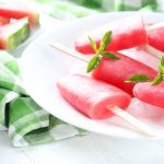 Watermelon Aloe Vera Popsicles Watermelon popsicle on plate on white wooden table